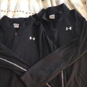 Two black under armour half zip pull over’s